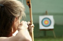 Archer spans the bow and aims to target.